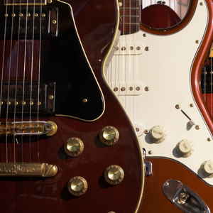 Close-up of three electric guitars with a blurred background