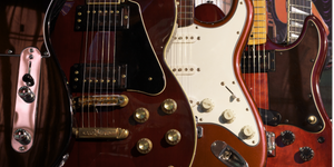 Close-up of three electric guitars with a blurred background